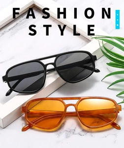 Classic double-bridge aviator sunglasses in black and tortoiseshell on marble background