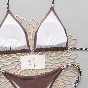 Detail of bikini top interior showing removable white chest pads and leopard print straps