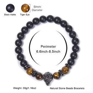 Men's Tiger Eye and Matte Onyx beaded bracelet with silver wolf head on white background