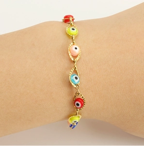 Detail shot of boho 18K gold evil eye beaded bracelet on wrist with vibrant colors