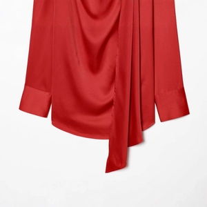 Elegant red satin long sleeve blouse with high neck and front drape design on white backdrop