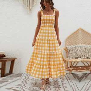 Detail of the layered pleated maxi skirt with yellow and white plaid pattern texture