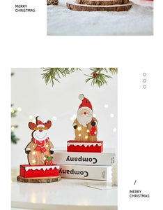 Close-up of wooden Merry Christmas LED ornament with Santa Claus and reindeer on a desk