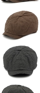 Detailed view of brown and dark grey herringbone newsboy caps with wool texture