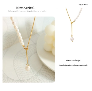 Detailed view of asymmetric freshwater pearl necklace with gold-plated snake chain