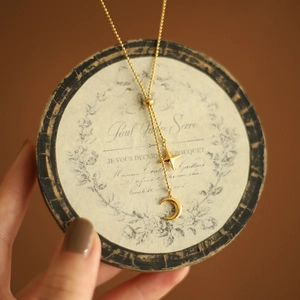 Minimalist gold plated star and moon pendant necklace with delicate bead chain design