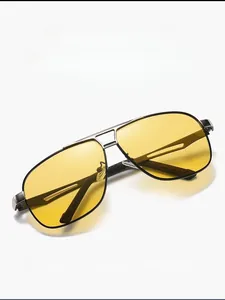 Detail view of yellow polarized lenses on aviator driving glasses with metal alloy frame