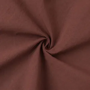 Detail of dark brown fabric texture showing soft draping and high-quality plain weave material