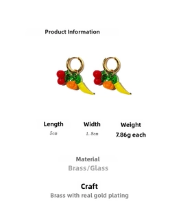 Detail view of 18K gold plated brass earrings featuring glass fruit and vegetable pendants