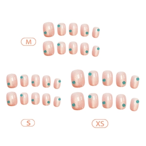 Cat eye press-on nails in pale pink with turquoise beads, displayed in XS, S, M sizes