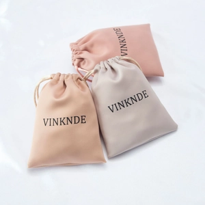 Three premium microfiber drawstring jewelry pouches in pink, beige and lavender colors