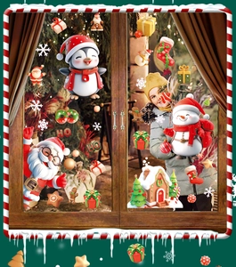 Close-up of Santa, snowman and penguin static cling stickers on a glass window pane