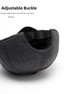 Detail of adjustable snap buckle and nylon strap on dark grey baseball cap for custom fit