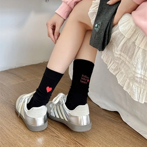 Detail of cotton crew socks featuring red heart embroidery and Follow your heart text