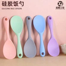 Vertical row of multi-colored silicone rice spoons with ergonomic handles and hanging holes