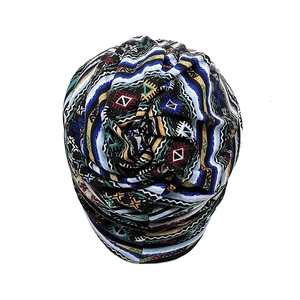 Detail of knit beanie featuring colorful ethnic geometric patterns and tribal wave motifs