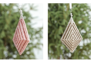 Detailed close-up of glittered geometric Christmas tree ornaments in purple and gold tones