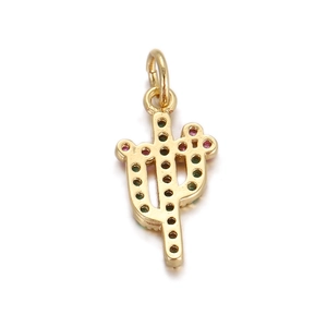 Detailed macro view of an 18K gold-plated cactus pendant with green and pink gemstones