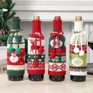 Close-up of knit Christmas wine bottle covers with festive snowman and reindeer patterns