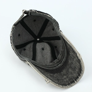 Internal view of washed black denim baseball cap showing sweatband and seam tape detail