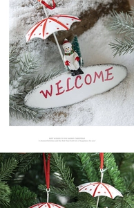 Detailed Christmas snowman pendant with red white umbrella and welcome sign on festive tree