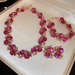 Detailed view of rose gold jewelry set with purple gemstones in a gift box