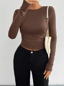 Detail view of the brown slim fit long sleeve knit top showing the soft elastic fabric texture