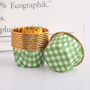 Macro view of green checkered cupcake liners with golden foil interior for baking