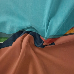 Detailed macro view of bohemian tapestry fabric with teal and orange artistic patterns