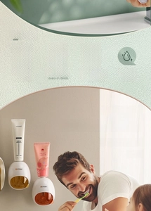 Detail of wall-mounted automatic toothpaste dispensers showing easy drill-free installation