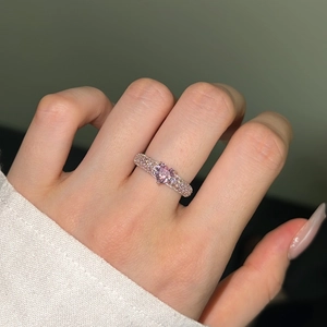 Macro detail of S925 silver ring featuring a pink heart stone and pavé-set crystals