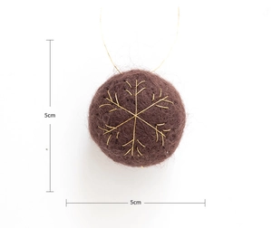 Detailed macro view of 5cm brown plush Christmas ball with gold snowflake embroidery