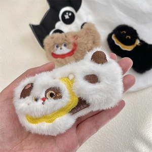 Close-up of cute plush cat brooches with exquisite embroidery in white and brown