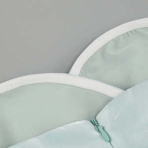 Detailed view of mint green dress showing non-slip silicone strip and invisible zipper