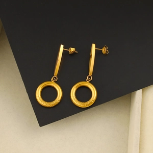Chic 18K gold plated stainless steel hoop earrings with textured finish on black background