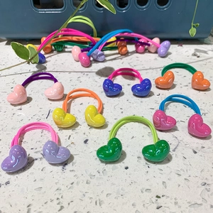 Detail of colorful macaron heart elastic hair ties in vibrant pink and blue shades