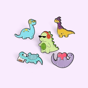 Set of five colorful cartoon enamel dinosaur pins with headphones on purple background