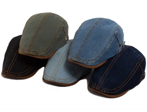 Detail of five denim flat caps in various colors with leather brim and contrast stitching