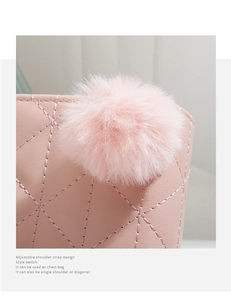 Detail of pink quilted PU leather bag with decorative fur pompom and adjustable strap