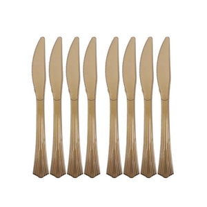 Set of eight gold plastic knives with serrated edges for party tableware decoration