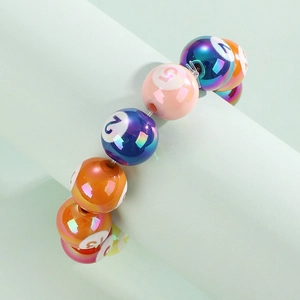 Colorful resin billiard ball bracelet with numbered beads on a stylish display stand