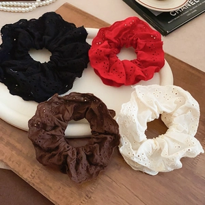Close-up of four double-layer lace scrunchies in white, red, brown, and black colors