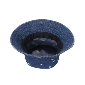 Navy blue denim bucket hat with daisy floral embroidery on white background