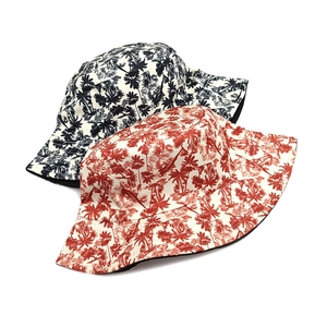 Detailed macro view of tropical palm tree prints on reversible sun bucket hats