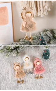 Close-up of plush Christmas angel ornaments with golden antlers and glitter hearts