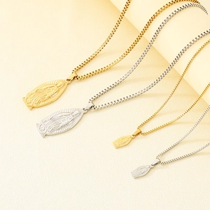 Detailed macro view of gold and silver Guadalupe Virgin Mary pendants with box chains