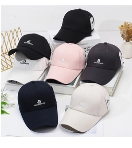 Detail showing various colors of baseball caps with embroidered B letter design