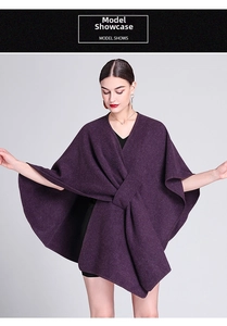 Detail showing purple knit shawl poncho with elegant twist knot design and warm texture