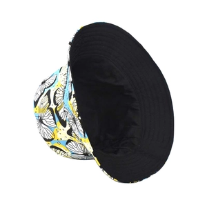 Detail view of the yellow butterfly print and reversible black lining of this bucket hat