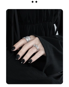 Detail of silver multi-layered rose flower rings with zircon inlays on hand